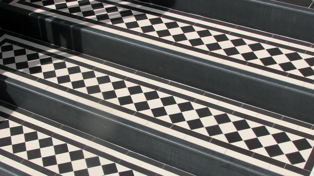 Granite step risers with checkerboard step treads.