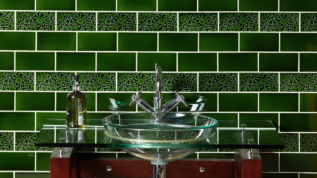 Victorian dark (racing) green wall tiles with modern utility room basin.