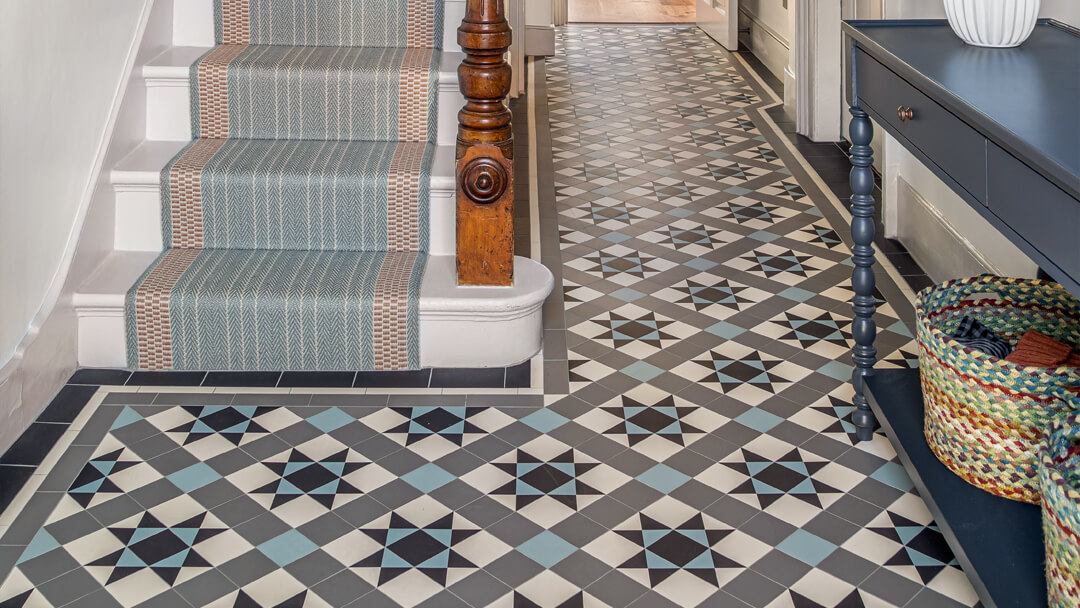 Reproduction Victorian hall flooring in a modern colour palette of black, white, grey and blue - the Stevenson design. New stair runner complements the tile colours.