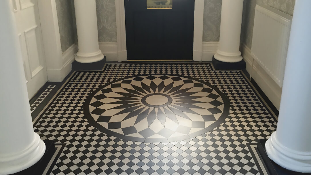 Custom cut, circular black and white ceramic tile motif in centre of large vestibule.